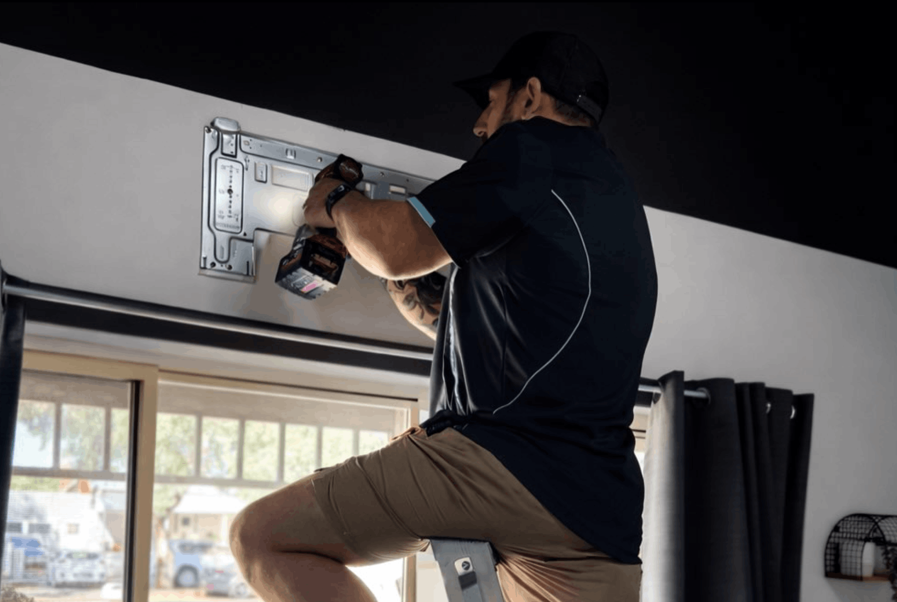 CHS technician mounting split system bracket in a Broken Hill home